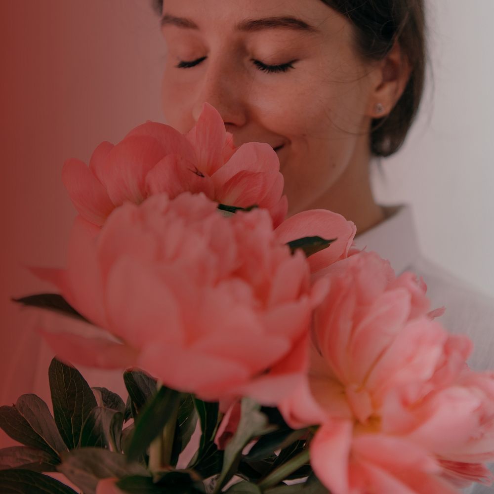 Woman smelling flower background, pink design