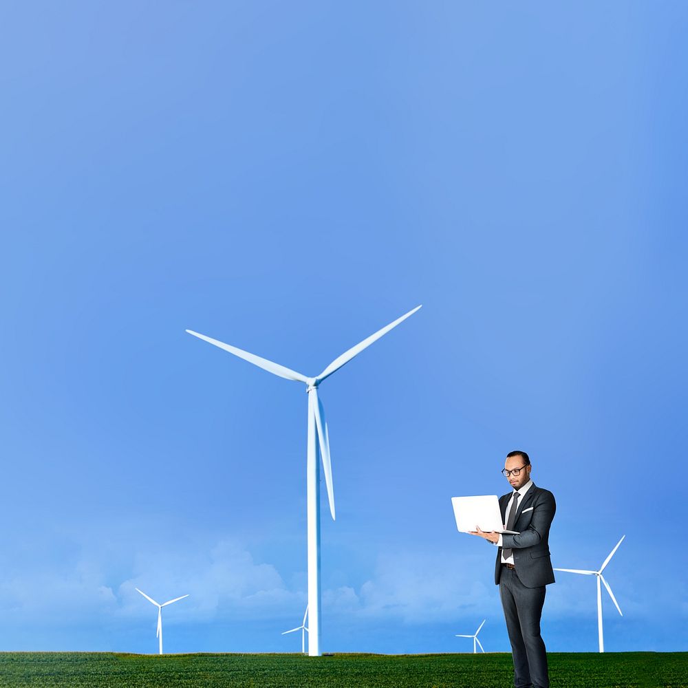 Wind turbine background, businessman using laptop image