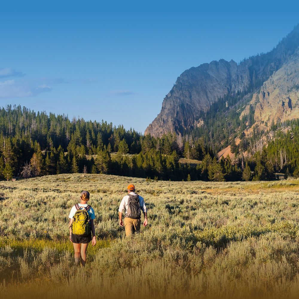 Mountain landscape background, travelers walking through grass