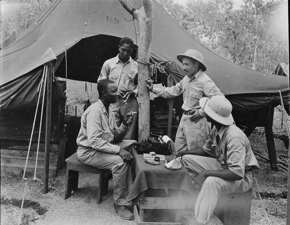 U.S. African American troops in New Guinea. First Lieutenant Theodore R. Frierson, Chaplain, U.S. Army, holding a conference…