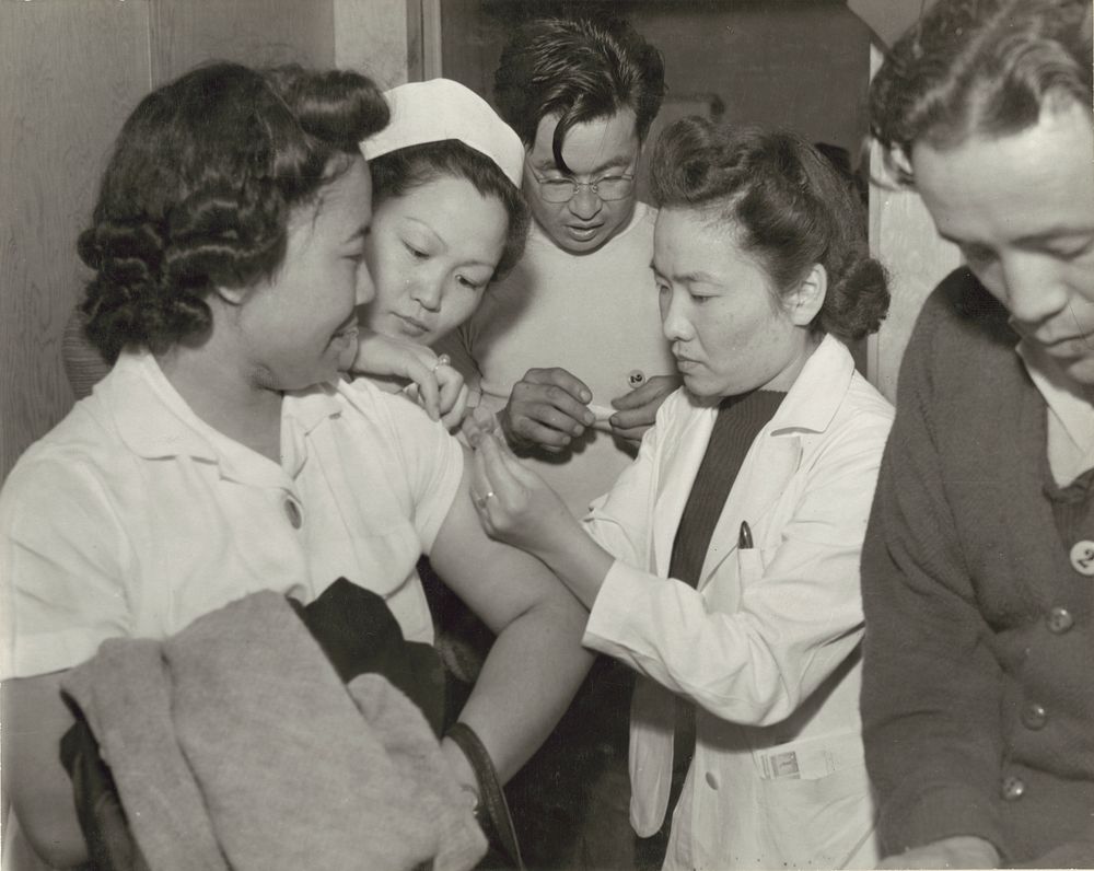 Japanese relocation, California. Newcomers at Santa Anita Park Assembly Center in Arcadia, California, receive vaccination…