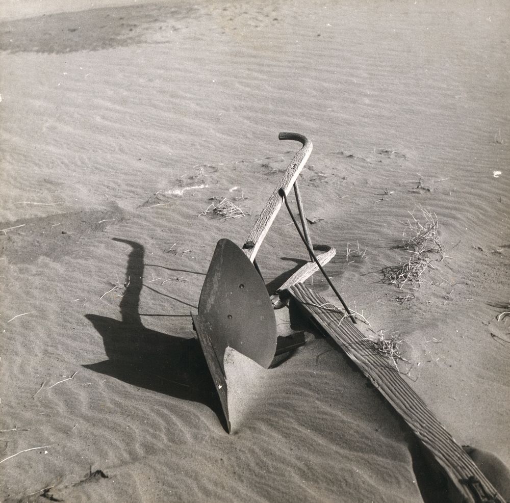 Plow covered by sand. Cimarron County, Oklahoma. Sourced from the Library of Congress.