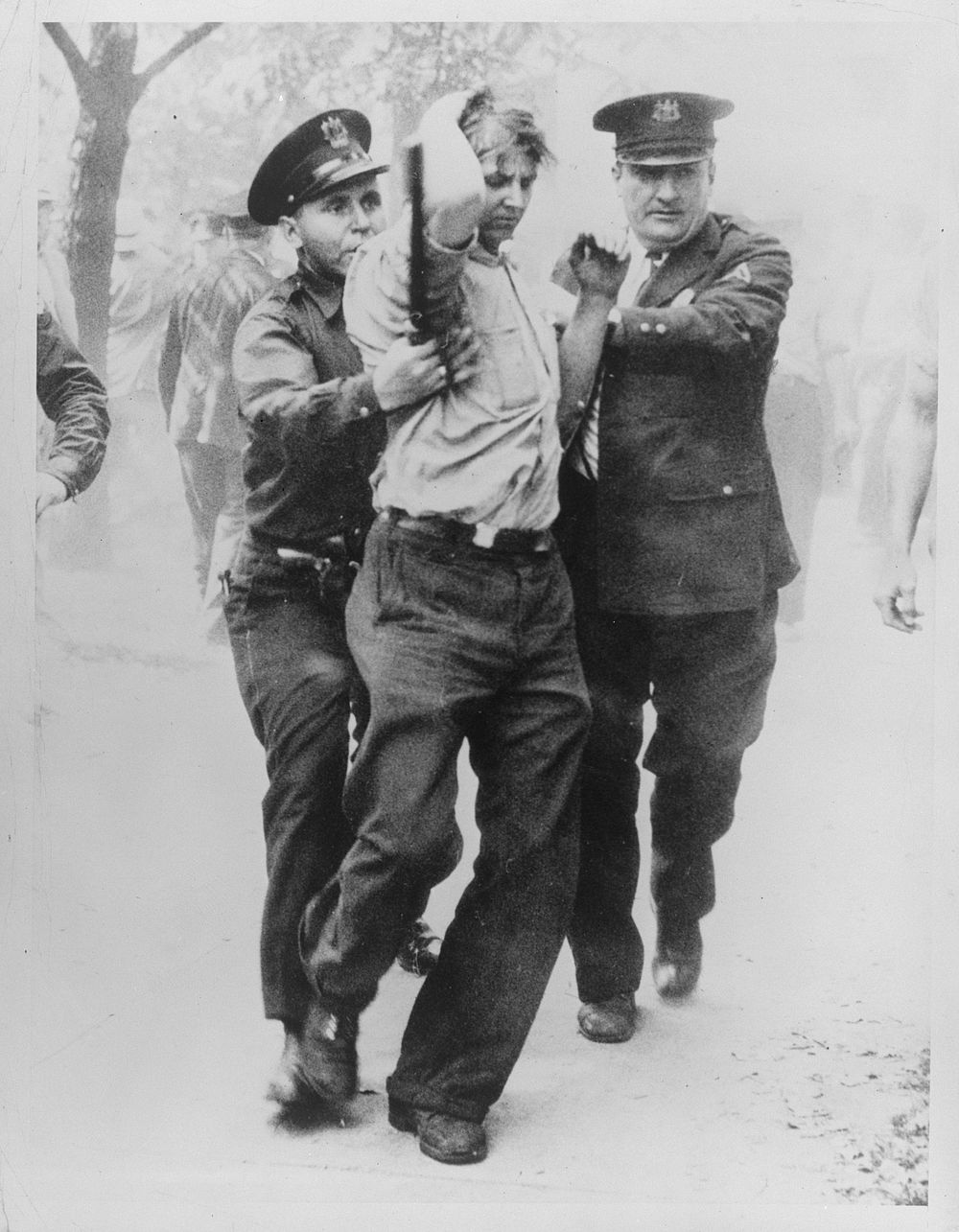 [Untitled photo, possibly related to: Detroit, Michigan. Police officers removing sit-down strikers from the Yale and Towne…