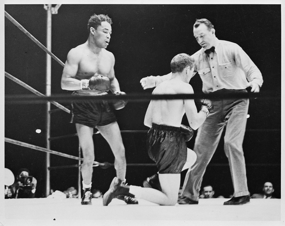 [Untitled photo shows: Henry Armstrong, boxing champion, with his opponent Lew Jenkins and referee Arthur Donovan at the…