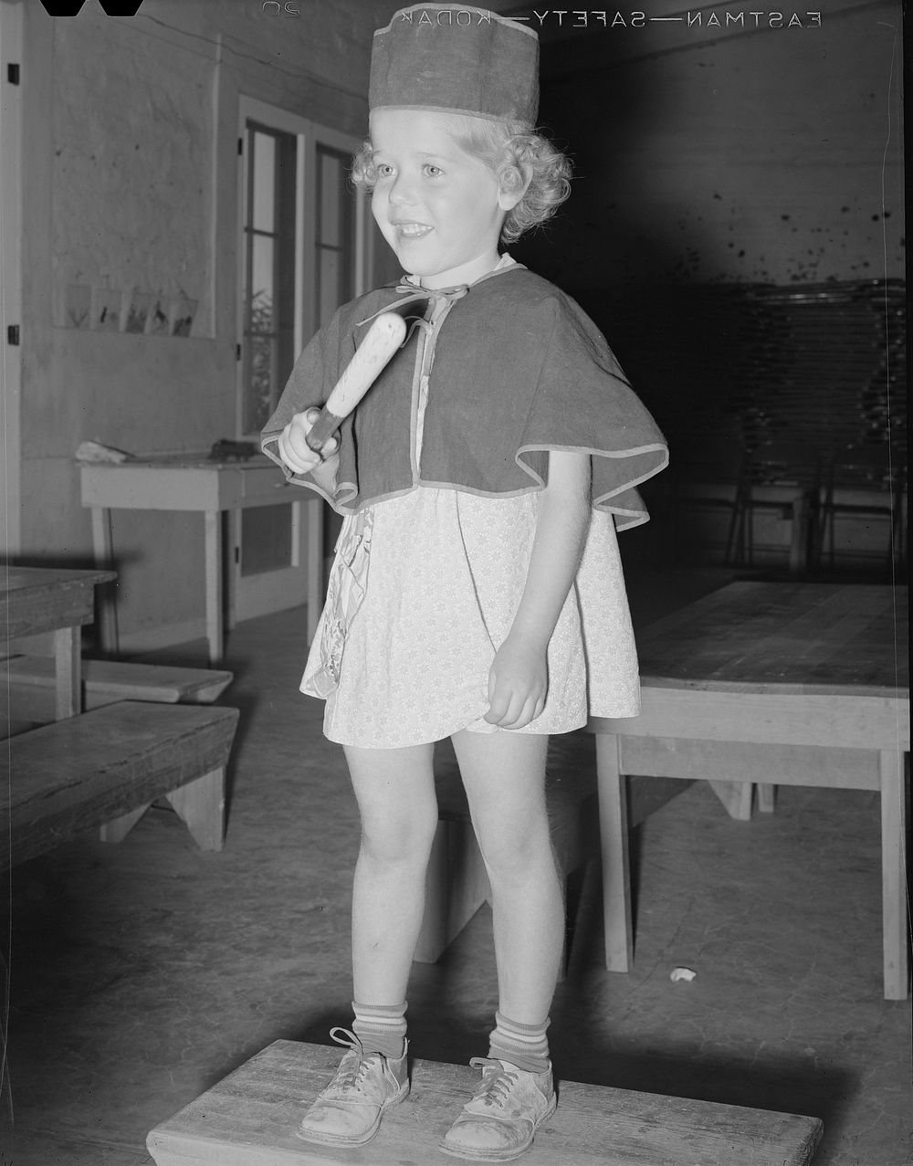 Little girl at the Casa Grande Valley Farms, Arizona, WPA (Work Projects Administration) nursery school leading the "band"…
