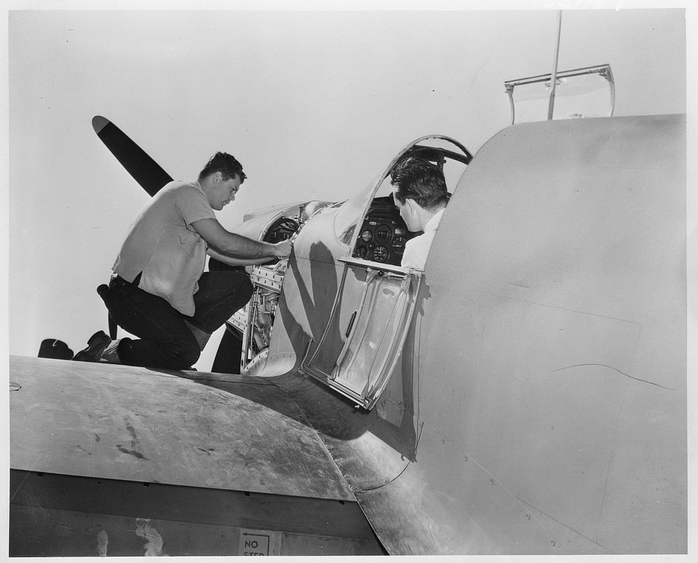 A North American P-51 fighter is given final inspection before its first test flight. Sourced from the Library of Congress.