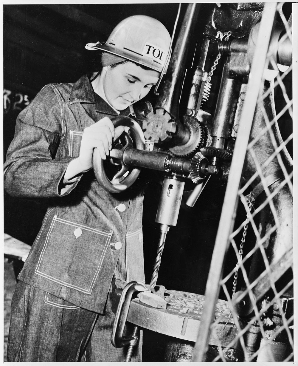 Drill press operator in a machine shop. Sourced from the Library of Congress.