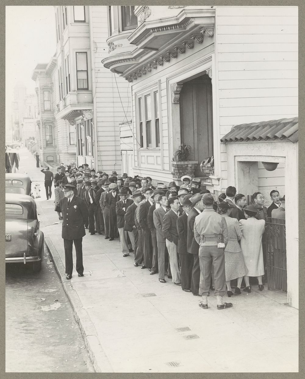 San Francisco, Calif. Apr. 1942. Evacuees of Japanese ancestry lining up before Japanese-American Citizens League to…