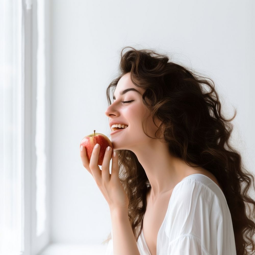 Biting eating adult apple. 