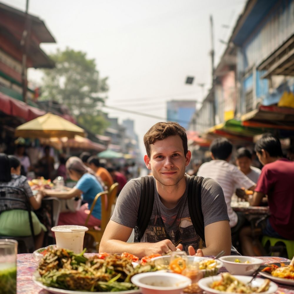 American man eating padthai food street adult. 