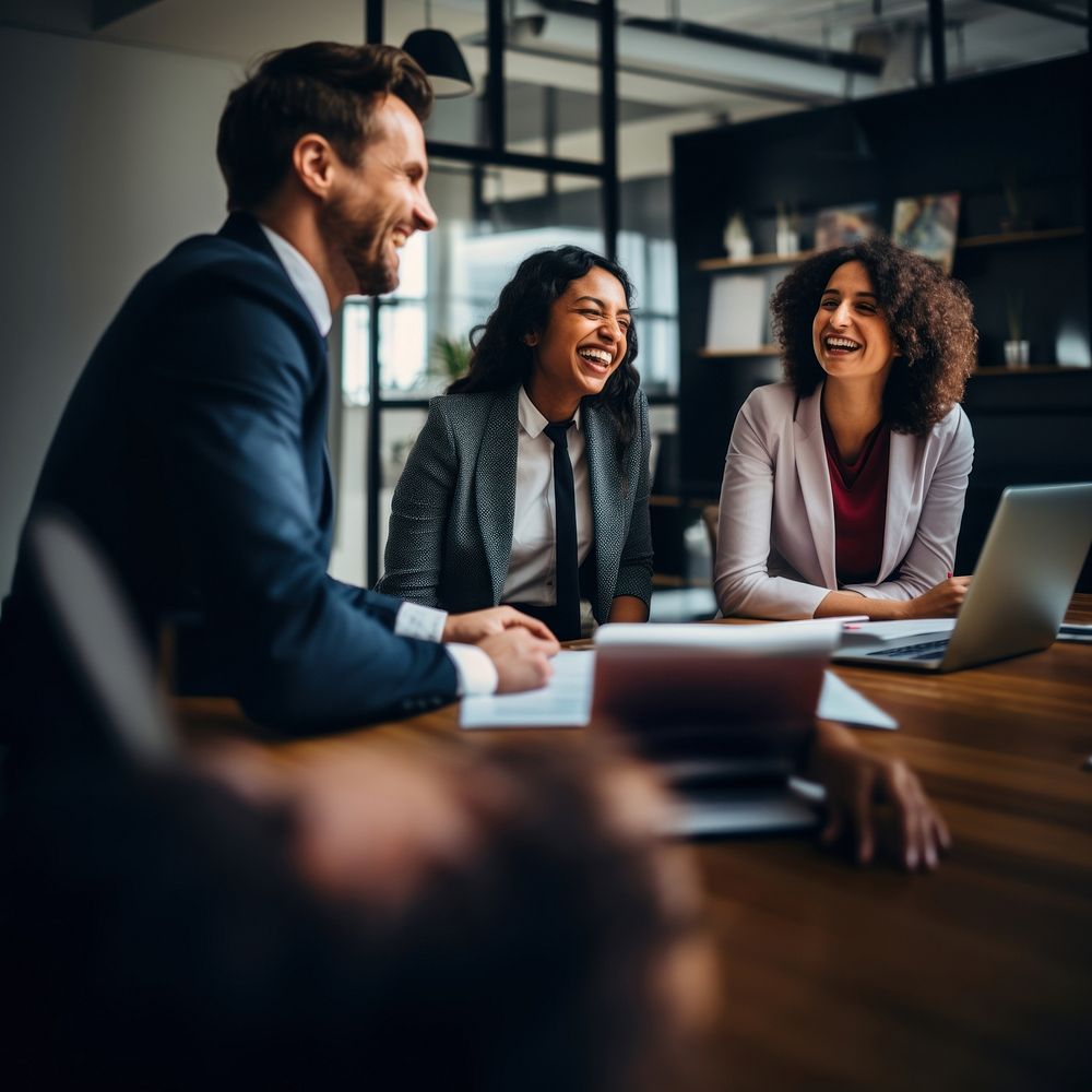 Photo of office workers laughing in the meeting room. 