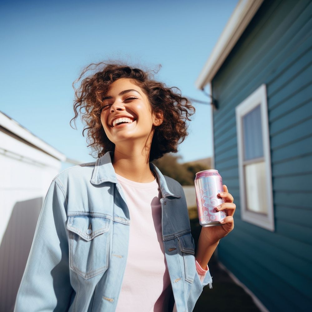 Portrait photo of a happy woman holding aluminum can looking at out side on minimal home. 