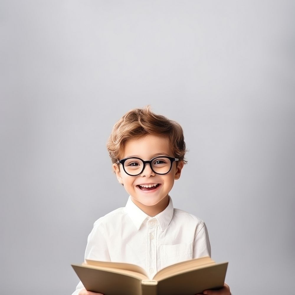 Kid boy wear glasses reading a book portrait publication photo. 