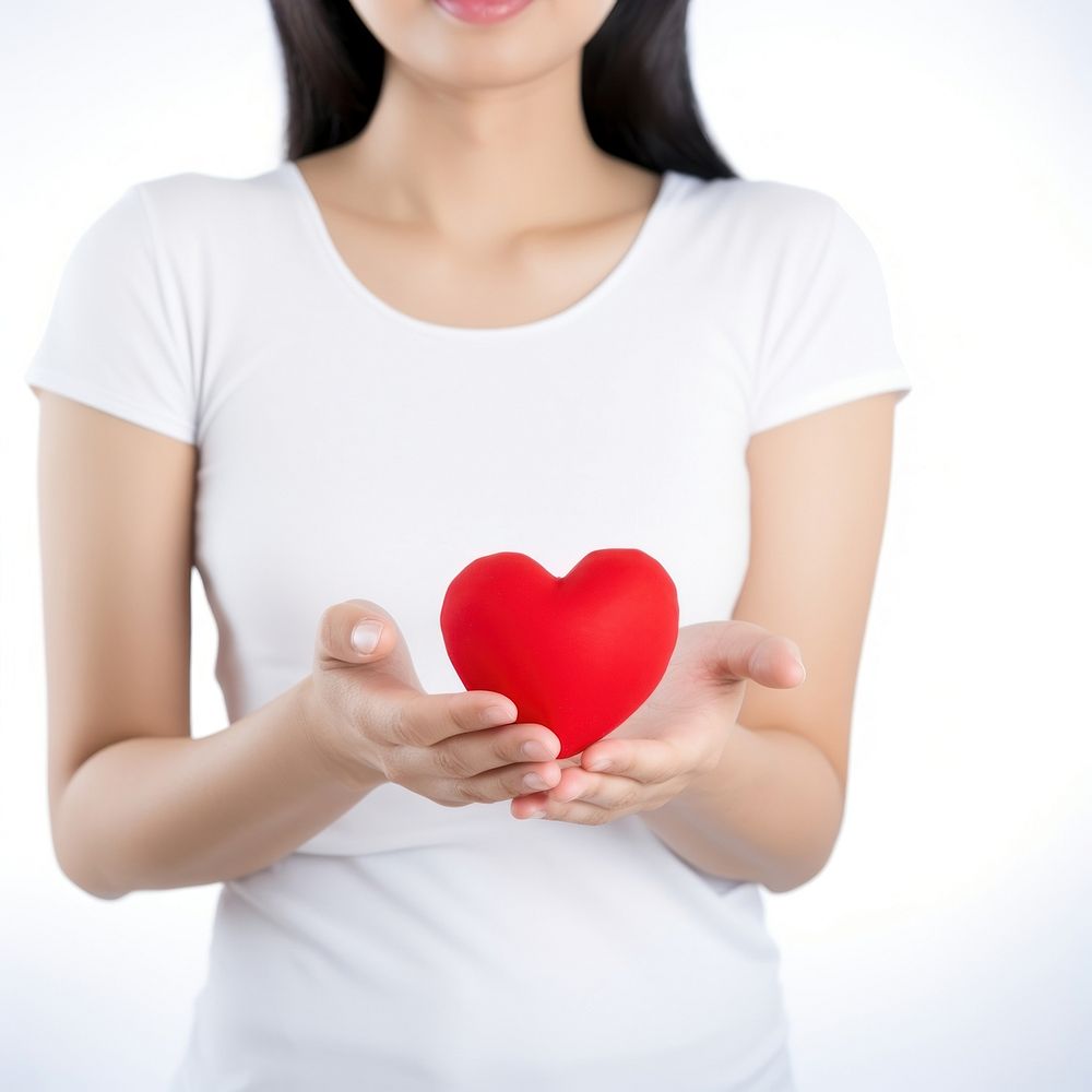 Heart shape t-shirt holding red. 