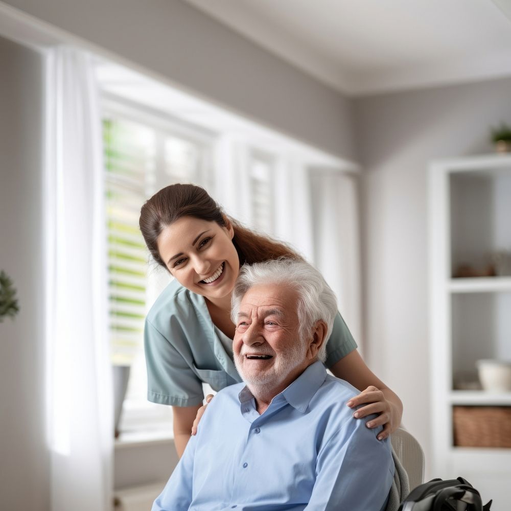 Caring female doctor embracing helping happy senior male disabled patient smiling adult care. 