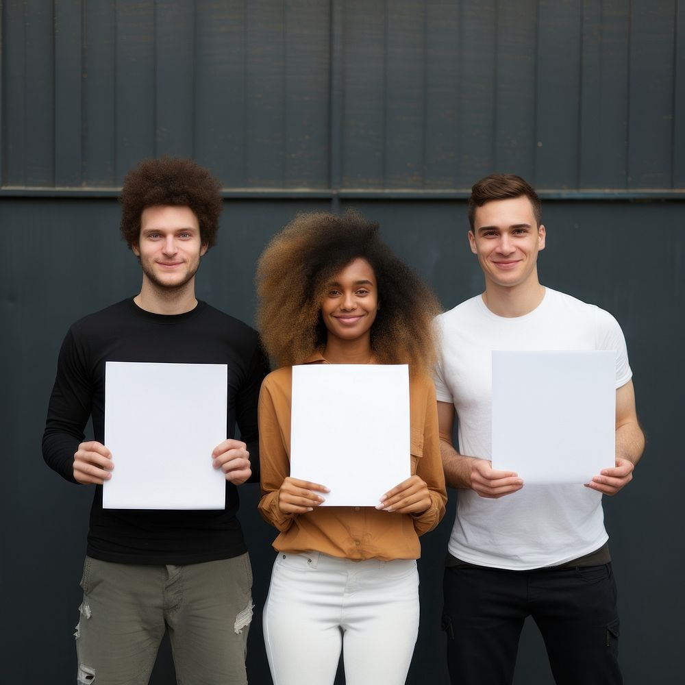 Volunteers holding paper portrait adult photo. 