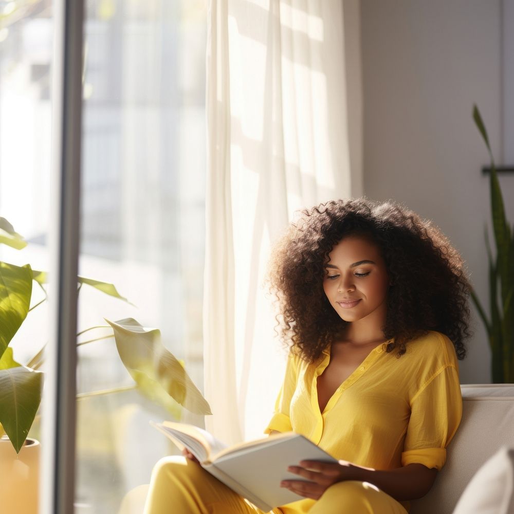 Photo of A relaxed trendy mixed-race african middle aged woman with long wavy hair with book. AI generated Image by…