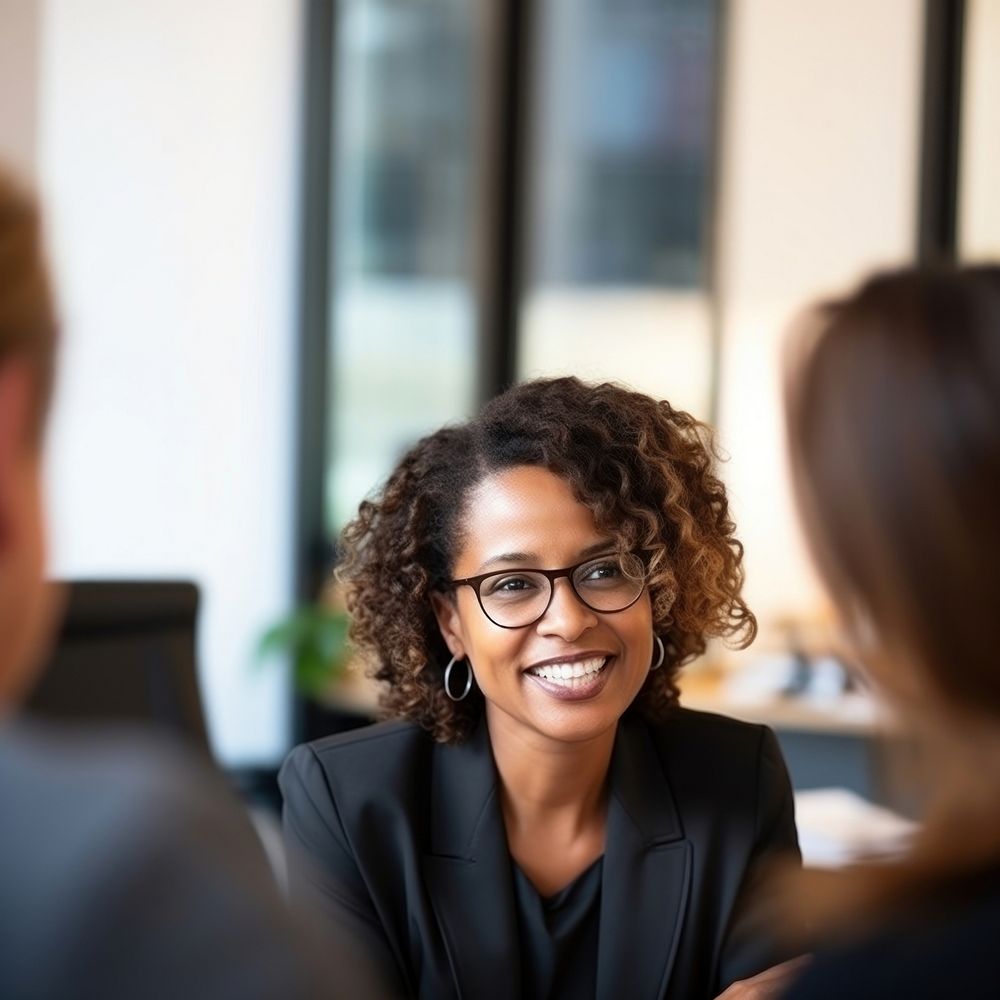 close up photo of a black middle age female lawyer with clients. AI generated Image by rawpixel. 