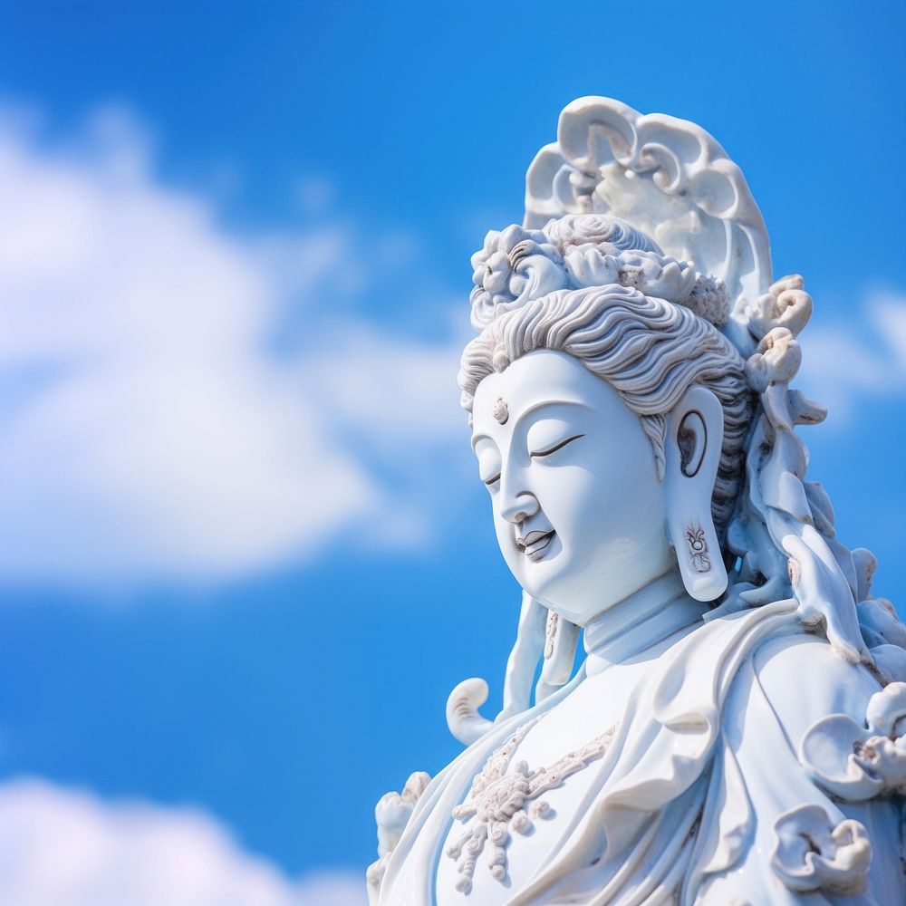 Guan Yin statue sculpture blue sky. 