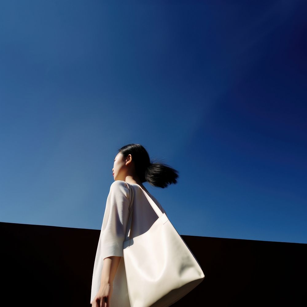 Asian woman holding a big tote bag handbag fashion adult. 