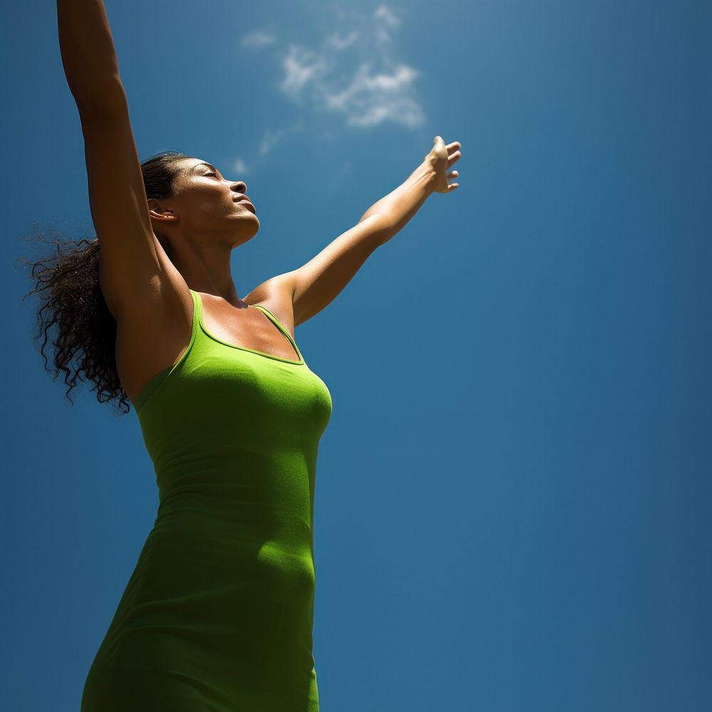 photo of mid-ages woman stretch the arms with bluesky and sun the green natual with blurred visio. AI generated Image by…