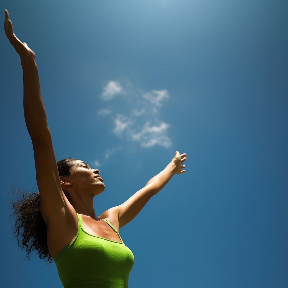 photo of mid-ages woman stretch the arms with bluesky and sun the green natual with blurred visio. AI generated Image by…