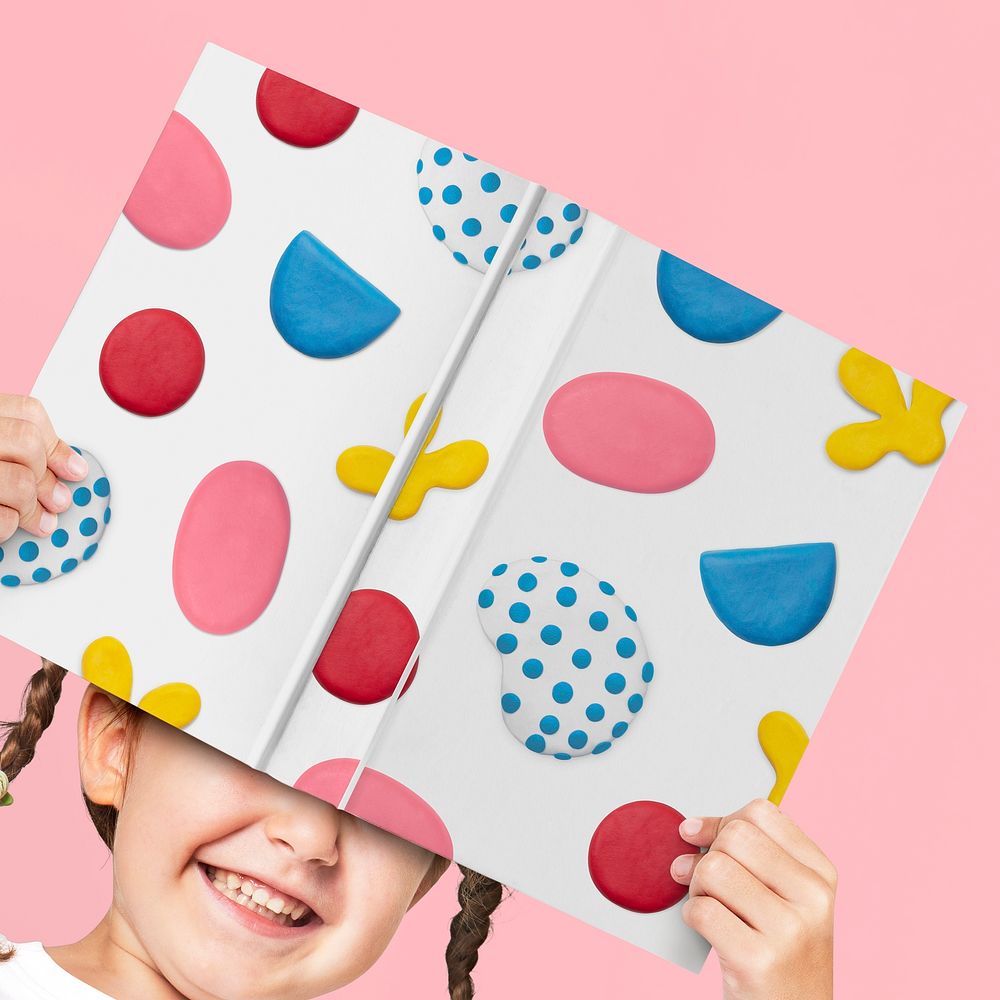 Book cover mockup psd with plasticine clay pattern holding by a girl