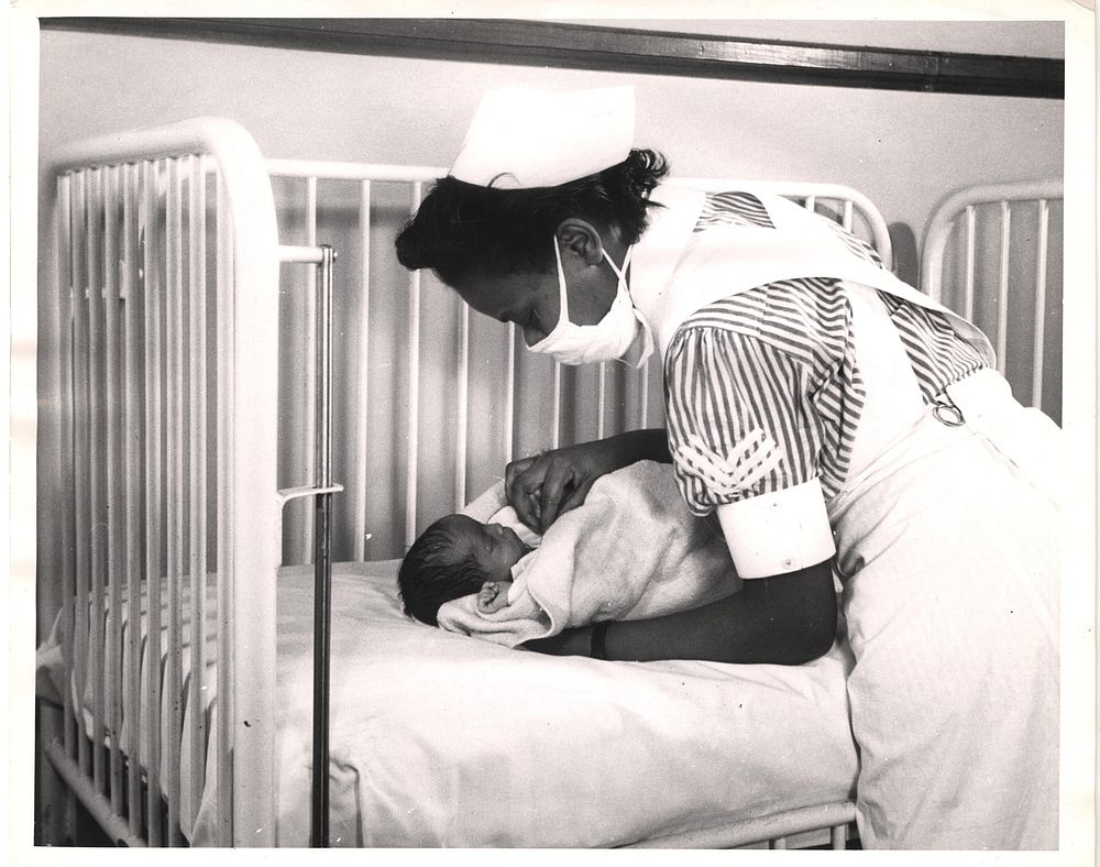 Newborn infant care. Original public domain image from Flickr