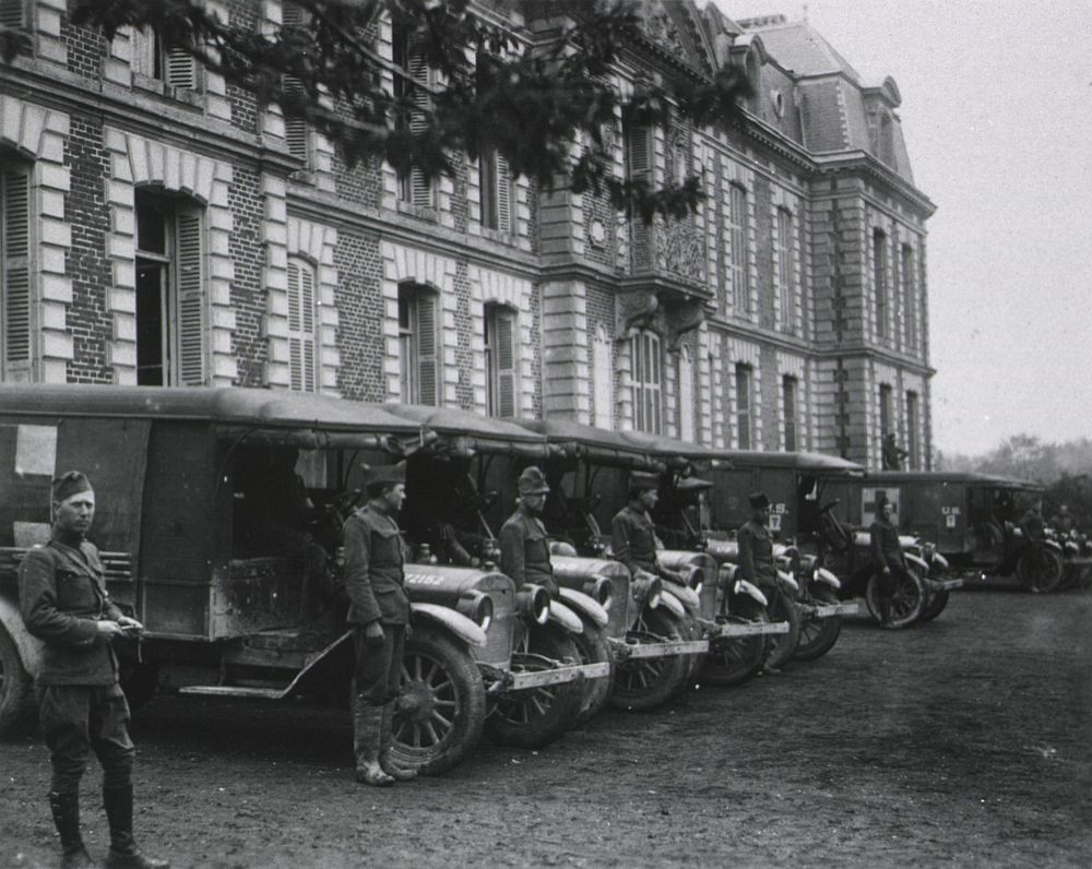 U.S. Army. Base Hospital No. 12. Bonvillers, France: Ambulances lined up prepared for an emergency call. Original public…