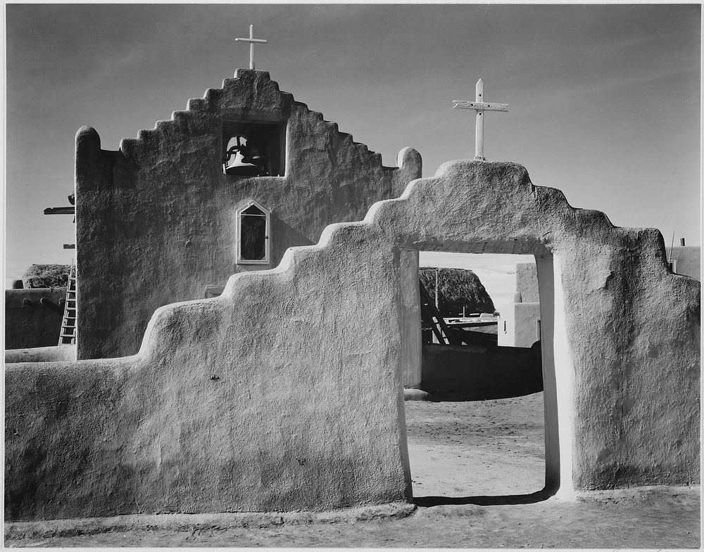 Full side view of entrance with gate to the right, "Church, Taos Pueblo National Historic Landmark, New Mexico, 1941."…