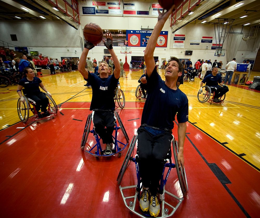 U.S. Sailors warm up before a preliminary wheelchair basketball game against an Air Force team at the inaugural Warrior…