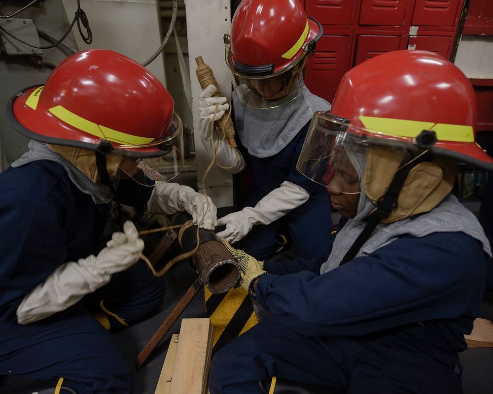 U.S. Sailors apply a pipe patch during a damage control drill on board the amphibious assault ship USS Wasp (LHD 1) in the…