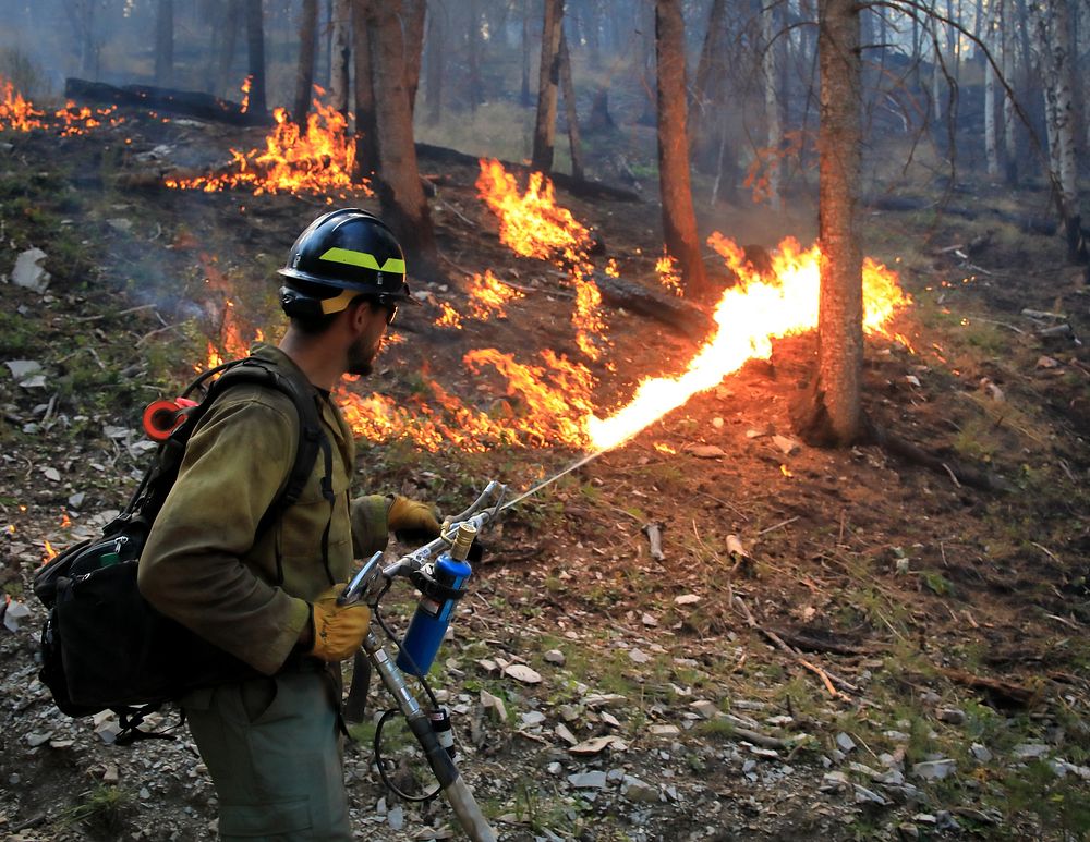 2022 BLM Fire Employee Photo Contest Category - Fuels ManagementA wildland firefighter ignites fuel during the 2022 Kyune…