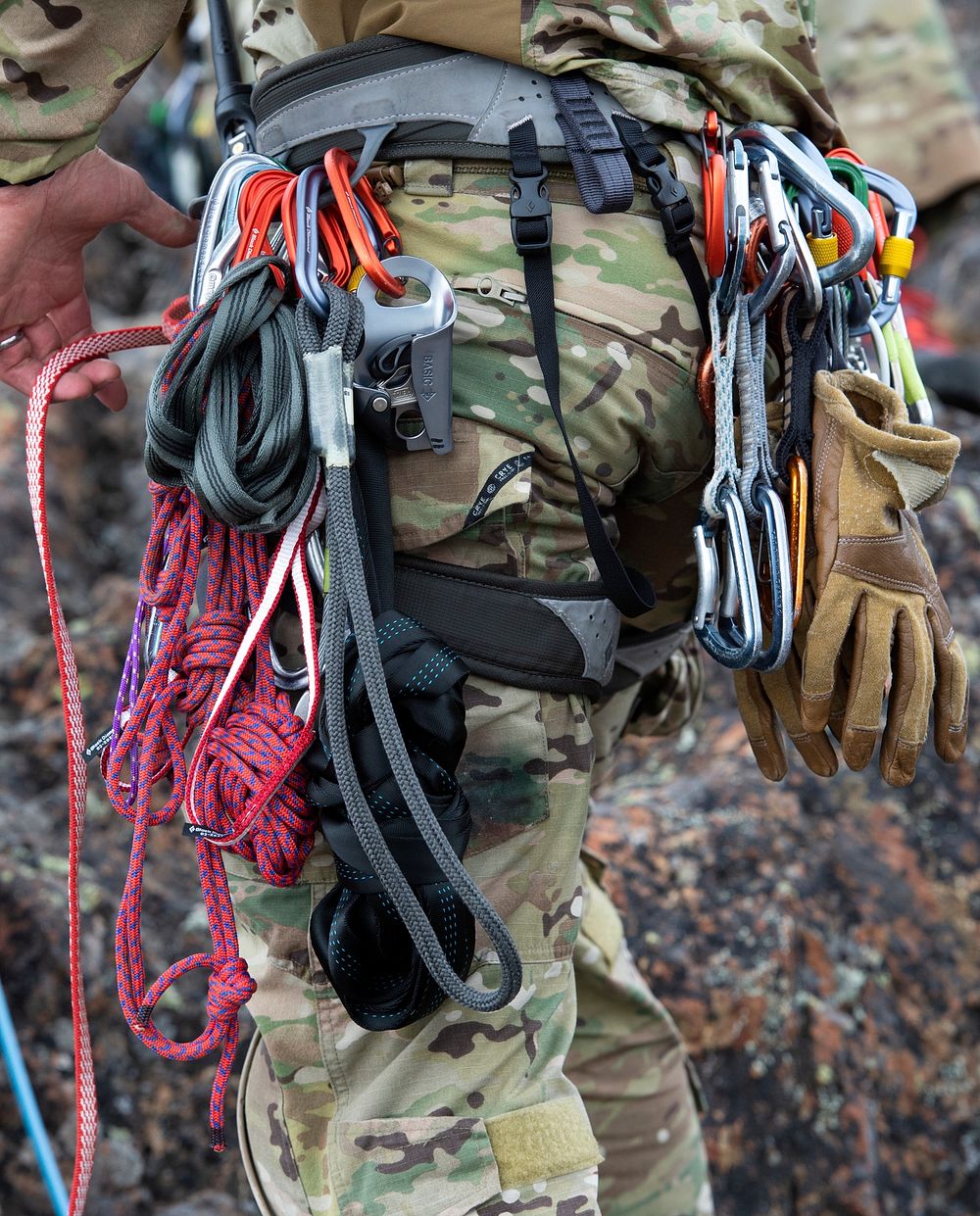 Climbing ropes and gear hang from the belt of a U.S. Air Force tactical air control party specialist assigned to Detachment…