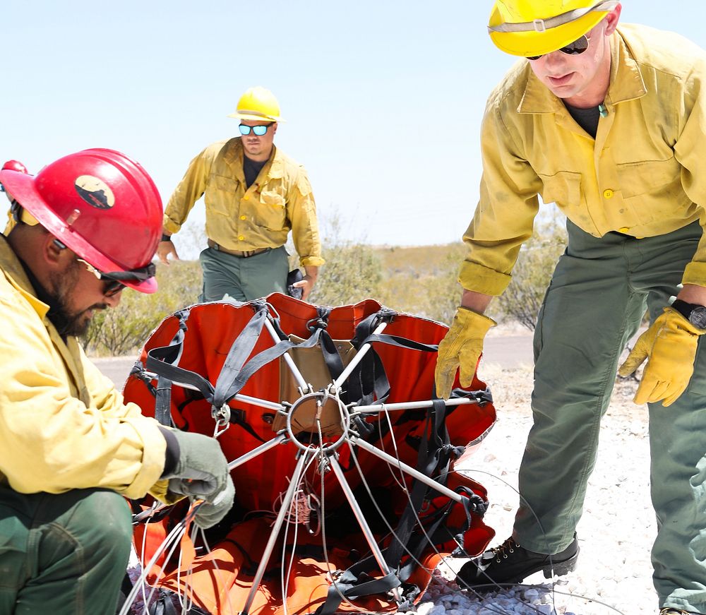 MAY 19: Preparing a helicopter bucketWICKENBURG, AZ - MAY 19: The Weaver Mountain helitack firefighters prepare a helicopter…