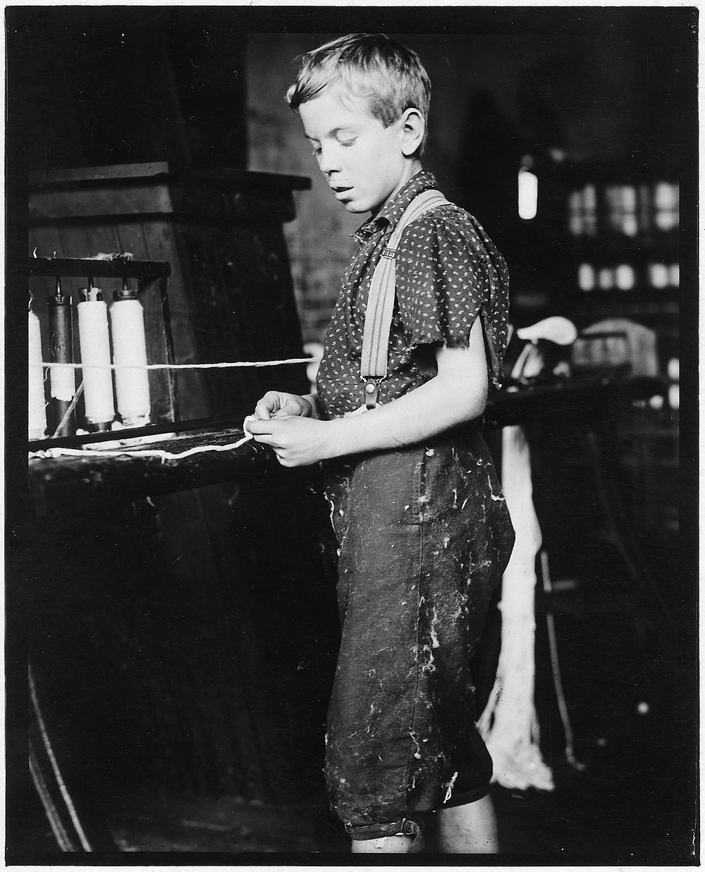 Youngster making bands, cotton mill. Clarence Noel, 11 years old. North Pownal, Vt, August 1910. Photographer: Hine, Lewis.…
