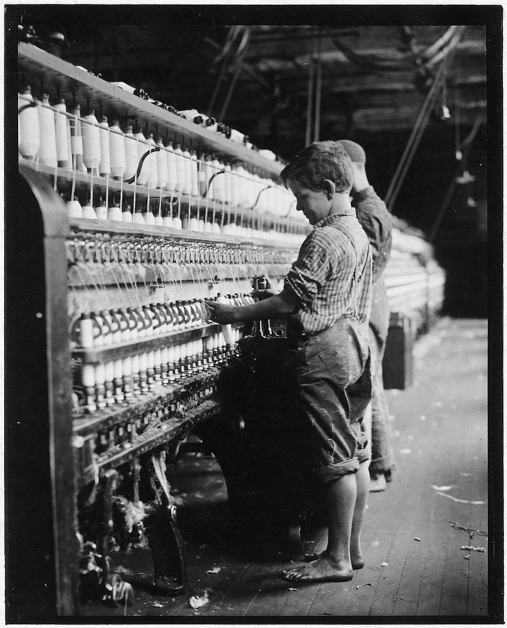Young doffer in North Pownal Mill. North Pownal, Vt, August 1910. Photographer: Hine, Lewis. Original public domain image…