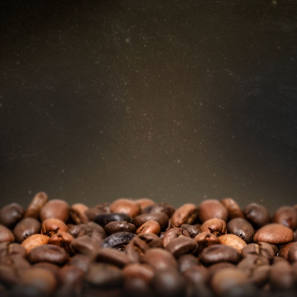 Roasted coffee beans, dark image with copy space