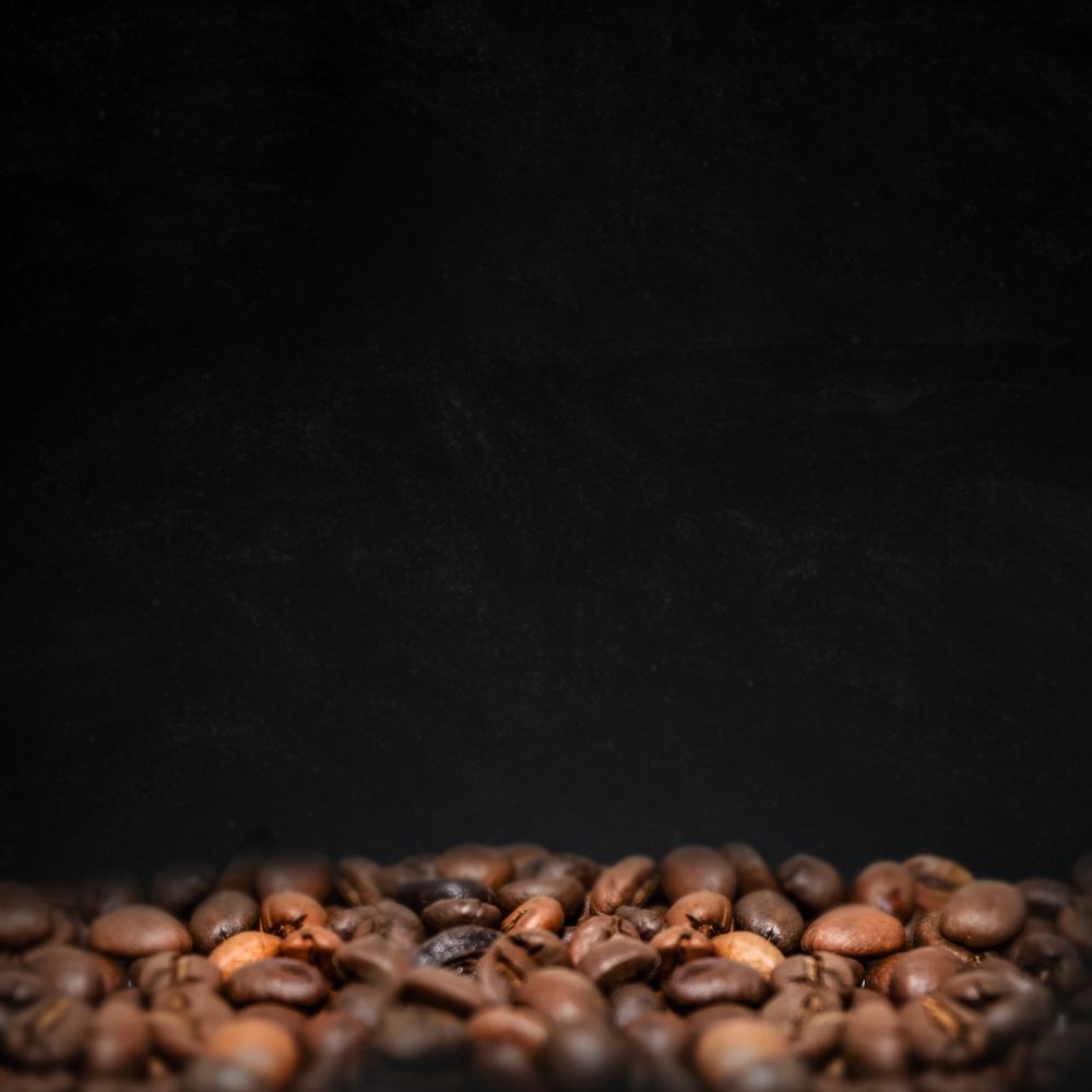 Roasted coffee beans, dark image with copy space