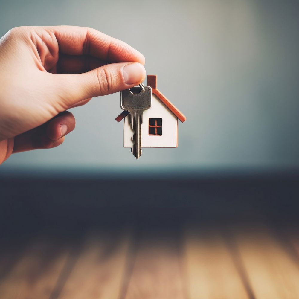 close up photo of black hand holding house key.  