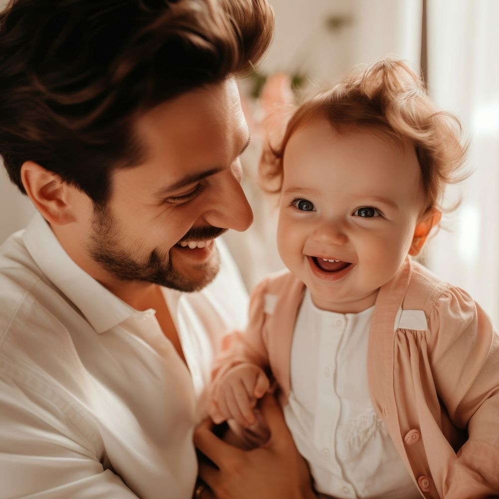 Man holding adorable baby smiling adult happy. 