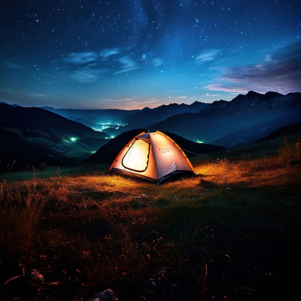 Photo of a tent, in a grass land, moutain in the background, at night, sky full of stars. 