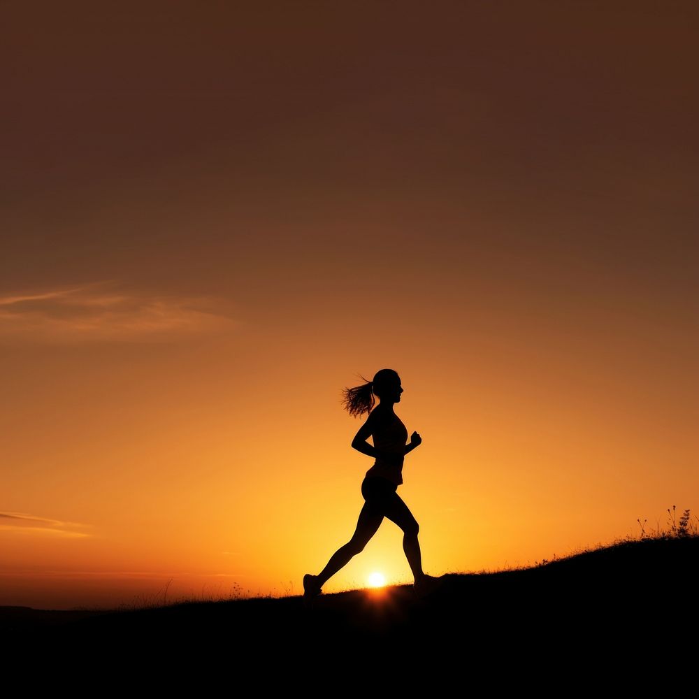 photo of silhouette woman run on the hill with sunset. 