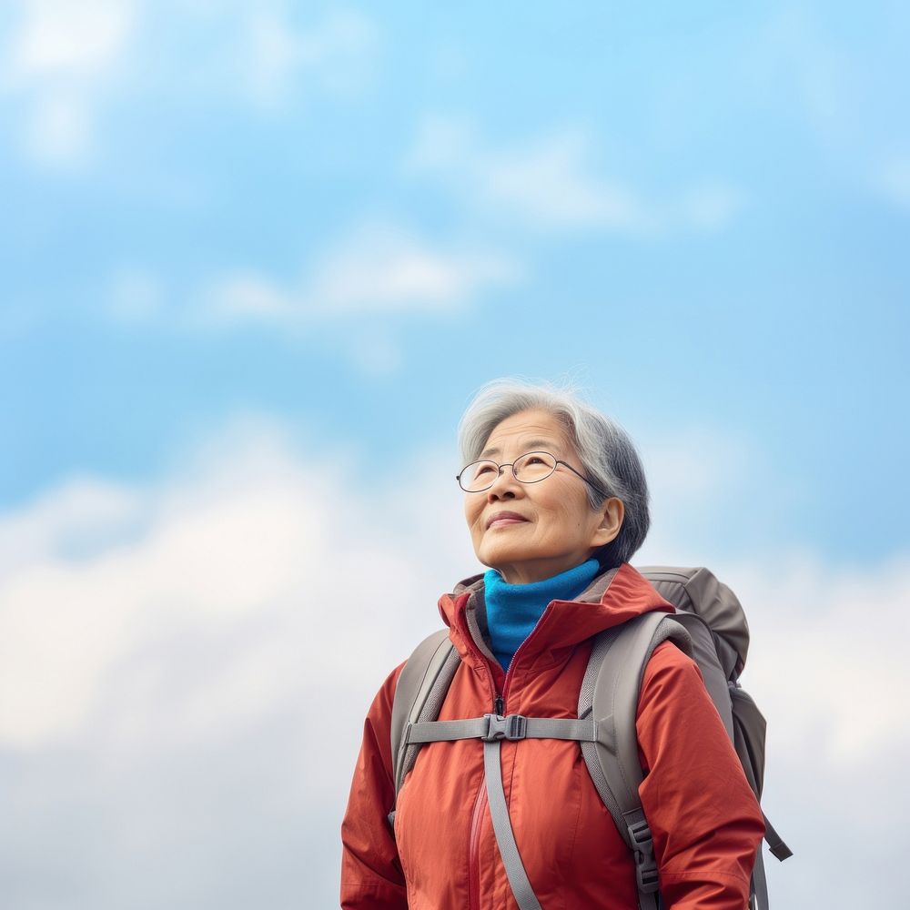 Senior woman hiking outdoors backpack looking. 