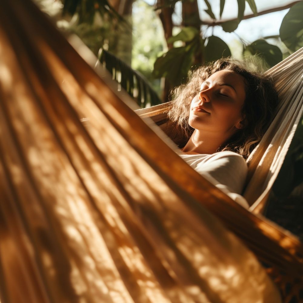 Woman napping on hammock. 