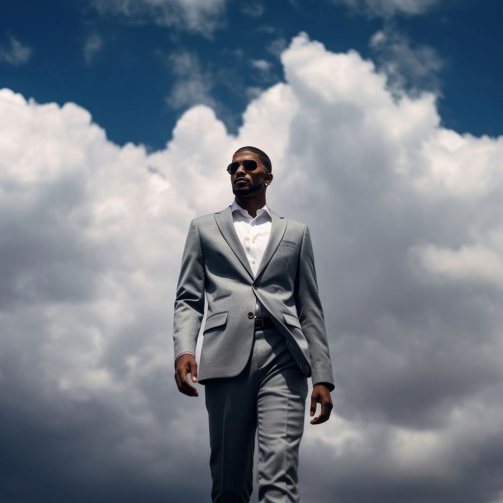 Black man cloud sky standing. AI generated Image by rawpixel.