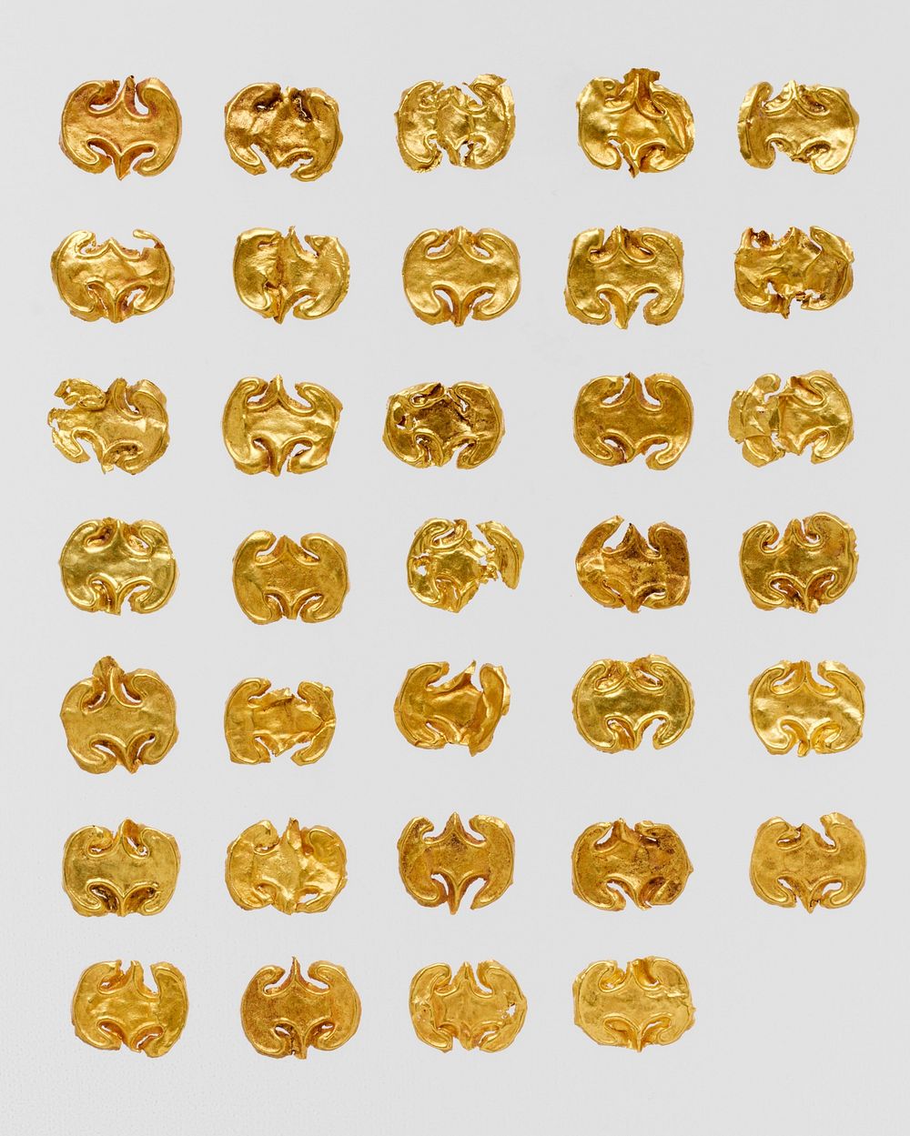 Thirty-four gold dress ornaments
