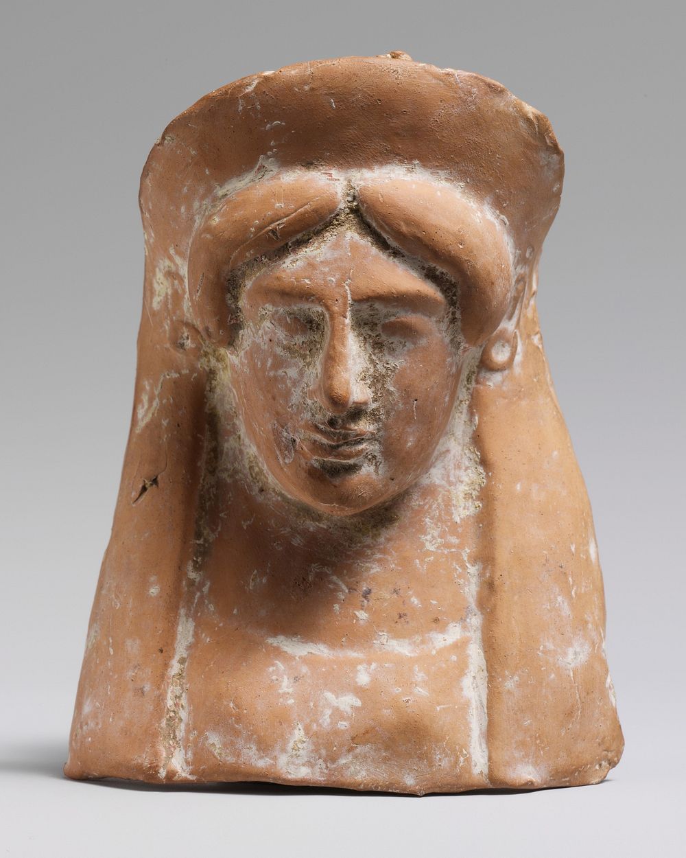 Terracotta relief with the head and neck of a woman