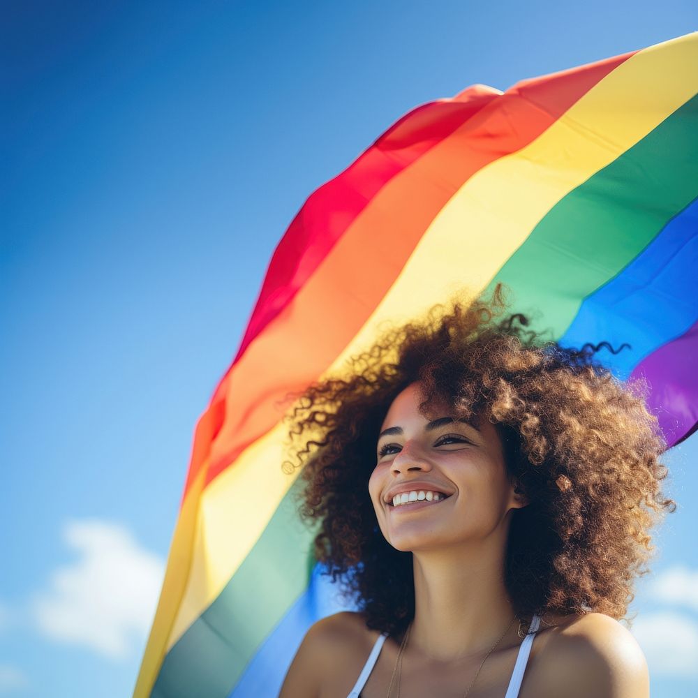 Woman holding pride flag smiling adult smile. AI generated Image by rawpixel.