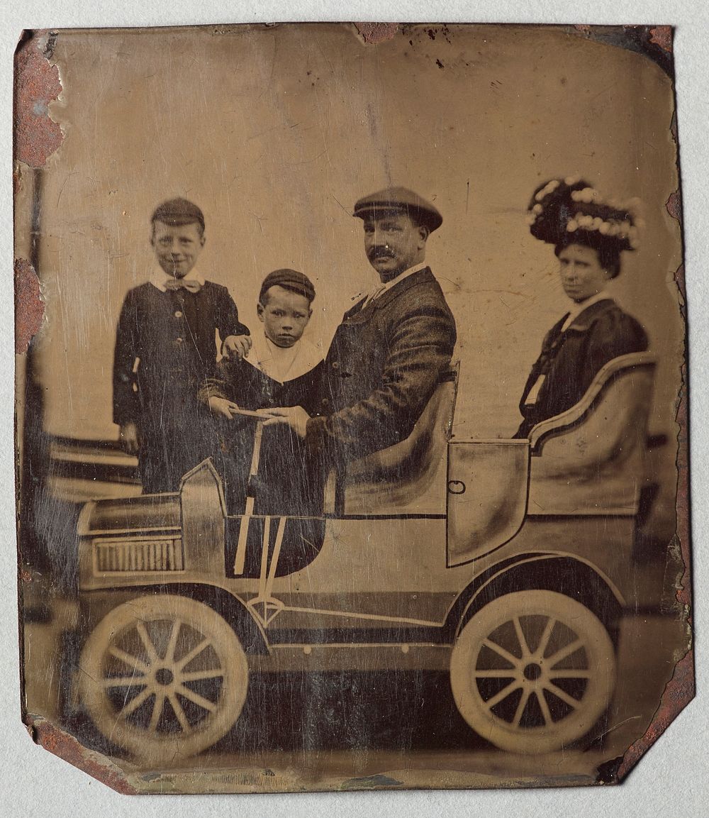 Family and cut out car (circa 1900).